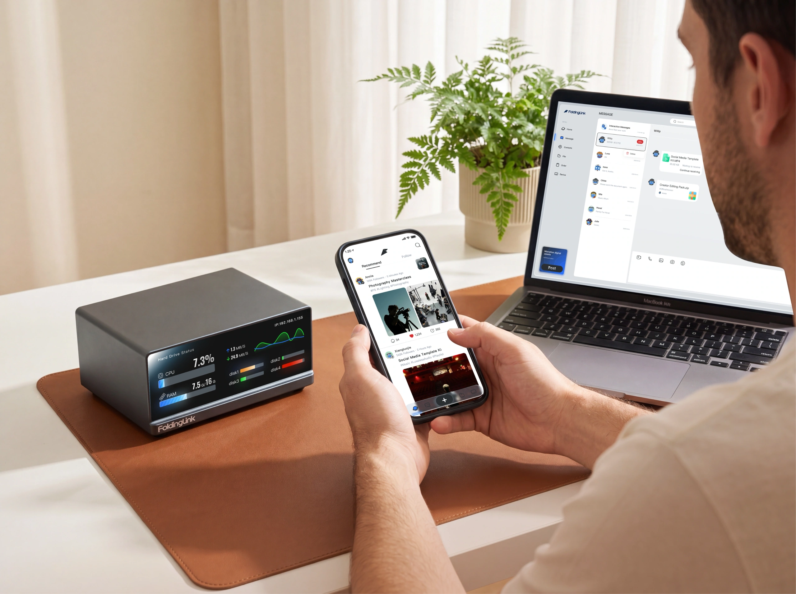 FoldingLink Box on a desk beside a phone showing a social feed